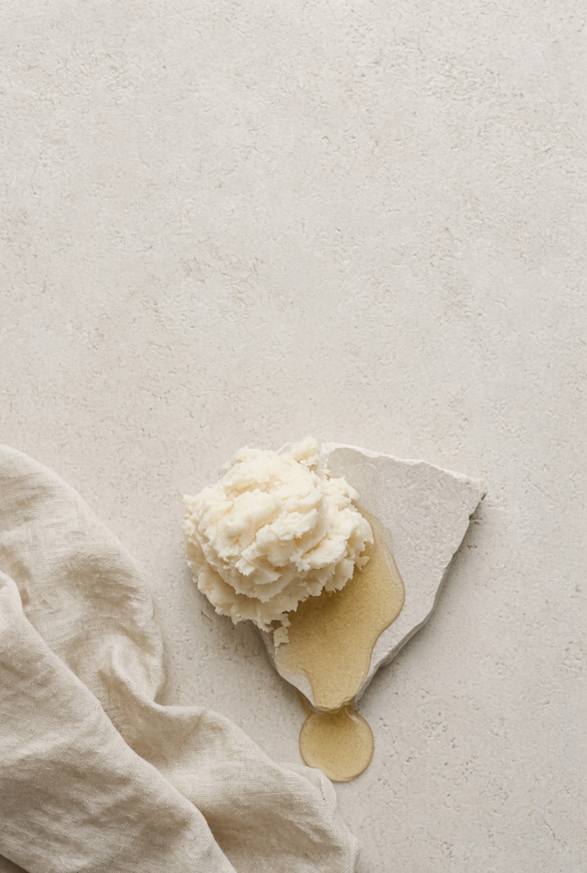 Raw shea butter and jojoba oil — the base every Wolf & 60 lotion starts from
